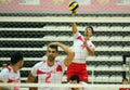 Volleyball player serves the ball