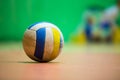 Volleyball separated on wooden floor