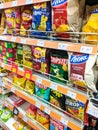 Volodymyr, Ukraine - 13.02.2022: supermarket aisle and shelves background with potato chips. Supermarket aisle with