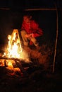 Vologda, July 2018, the day of Ivan the bath. a man sits by the fire and boils tea in a bucket Royalty Free Stock Photo