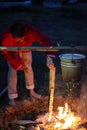 Vologda, July 2018, the day of Ivan the bath. a man sits by the fire and boils tea in a bucket Royalty Free Stock Photo