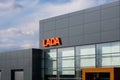 Vologda, Russia - May 3, 2020: logo lada dealership center building on a blue sky background with clouds. sign of a vehicle cente