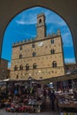 Volterra in Tuscany, town hall square with characteristic and colorful local Italian market