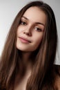 Volume Hair. Beauty Woman with Very Long Healthy and Shiny Smooth Brown Hair. Model Brunette Girl Portrait isolated on a gray Royalty Free Stock Photo