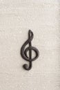 Volumetric black treble clef on rough surface. Music concept. Music symbol. Key of G