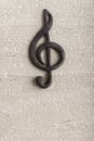 Volumetric black treble clef on rough surface. Music concept. Music symbol. Key of G. Vertical frame
