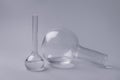 Volumetric flasks with liquid on grey background