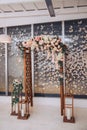 A voluminous wedding arch decorated with flowers, candlesticks and decorative butterflies. Royalty Free Stock Photo