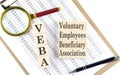 Voluntary Employees Beneficiary Association Plan VEBA text on wooden block on chart background