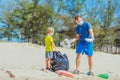 Volunteer blue face mask forest sand beach. Son helps father hold black bag for pick up garbage. Problem spilled rubbish