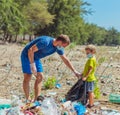 Volunteer blue face mask forest sand beach. Son helps father hold black bag for pick up garbage. Problem spilled rubbish