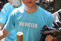 Volunteer in blue t-shirt holding garbage bag, ecology man cleaning and picking up trash to reduce land pollution environmental Royalty Free Stock Photo