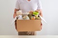 Volunteer with box of food for poor. Donation concept. Royalty Free Stock Photo