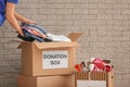 Volunteer collecting clothes into donation boxes