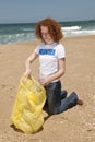 Volunteer collecting garbage on beach