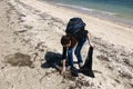 Volunteer collecting garbage on beach