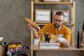 Volunteer collecting grocery products into donation box. Food donation, charity, food bank, help for poor families Royalty Free Stock Photo