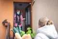 Volunteer delivering groceries to senior woman Royalty Free Stock Photo