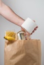 Volunteer with donation box with foodstuffs. Male hands hold a set of food products in a paper bag Royalty Free Stock Photo