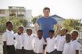 Volunteer and elementary school kids in playground, portrait Royalty Free Stock Photo