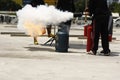 volunteer firemen training staff how to safely use a fire extinguisher