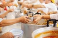 Volunteer food servers dish out a free charity : concept of helping Royalty Free Stock Photo