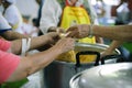 Volunteer food servers dish out a free charity : concept of helping Royalty Free Stock Photo