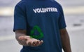 Volunteer, hand and recycle sign with hologram, carbon footprint and save the earth with awareness. Black man, male and Royalty Free Stock Photo