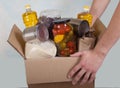 Volunteer hands hold food box for donation. Social, Help. Epidemic. Close-up