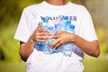 Volunteer hands, plastic bottle and park for community service, recycling and climate change or earth day project