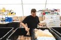 Volunteer man preparing donation boxes for people.