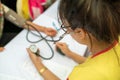 Volunteer nurse measuring blood pressure of poor Asian people outdoors closeup