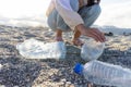Volunteer pick plastic bottle at beach