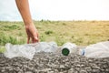 The volunteer picking up a bottle plastic in to a bin bag for cleaning, volunteering concept.