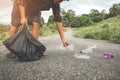 The volunteer picking up a bottle plastic in to a bin bag for cleaning, volunteering concept.