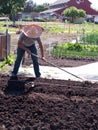 Volunteer preparing soil at community farm