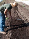 Volunteer preparing soil at community farm