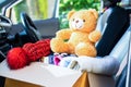 Volunteer provide clothing donation box with used clothes and doll in car to support help for refugee, homeless or poor people in