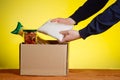 A volunteer puts food in a donation box. Assistance to the poor people under conditions of self-isolation during a Royalty Free Stock Photo