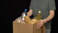 Volunteer putting food in a donation box Royalty Free Stock Photo