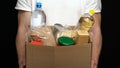 Volunteer putting food in a donation box Royalty Free Stock Photo