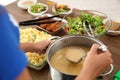 Volunteer serving food to poor people in charity centre Royalty Free Stock Photo