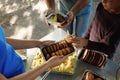 Volunteer serving food to poor people outdoors Royalty Free Stock Photo