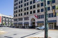 The Volunteer State Life Building with an American flag and Tennessee State flag flying surrounded by buildings with blue sky