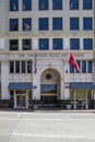 The Volunteer State Life Building with an American flag and Tennessee State flag flying surrounded by buildings in downtown
