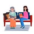 Volunteer takes care elderly woman. Social worker reads book old woman. Smiling young Lady sits in the sofa with grandma Royalty Free Stock Photo