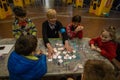 a volunteer teacher plays with children living in the Kharviv metro