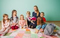Volunteer teacher reading to a class of kids Royalty Free Stock Photo