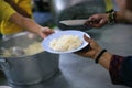 Volunteer to Feed the Hungry in Society: The Concept of Donating Food to the Poor in Society Royalty Free Stock Photo