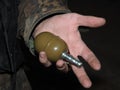 Volunteer in Ukrainian camouflage hold grenade.